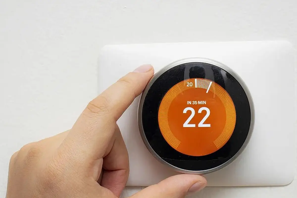 Furnace Repair Monterey Park CA — homeowner adjusting a wall thermostat